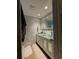 Modern bathroom with glass door vanity, tiled walls, and recessed lighting at 4981 Lake Cecile Dr, Kissimmee, FL 34746