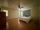 Spacious bedroom with hardwood floors, neutral walls, and windows providing plenty of natural light at 4981 Lake Cecile Dr, Kissimmee, FL 34746