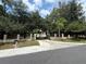 Long driveway leading to a gated property with mature trees and landscaped grounds offering seclusion at 4981 Lake Cecile Dr, Kissimmee, FL 34746