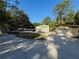 Exterior shot of garages surrounded by mature trees, showcasing the property's storage capabilities at 4981 Lake Cecile Dr, Kissimmee, FL 34746