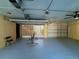 Large garage with painted epoxy floor, featuring ample storage and a ceiling fan at 4981 Lake Cecile Dr, Kissimmee, FL 34746