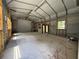 Spacious garage interior with roll up door, windows, and metal framing at 4981 Lake Cecile Dr, Kissimmee, FL 34746