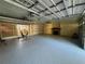 Spacious garage with epoxy flooring, ample storage, and a cozy fireplace feature at 4981 Lake Cecile Dr, Kissimmee, FL 34746