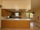 Kitchen featuring wooden cabinetry, appliances, and a breakfast bar at 4981 Lake Cecile Dr, Kissimmee, FL 34746