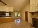 Spacious living room featuring a brick fireplace, tile floors, and a breakfast bar at 4981 Lake Cecile Dr, Kissimmee, FL 34746