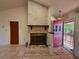 Living room featuring a brick fireplace, tile flooring, and an open doorway to a covered porch at 4981 Lake Cecile Dr, Kissimmee, FL 34746