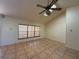 Light-filled living room featuring vaulted ceilings, skylights, large windows, and neutral-toned flooring at 4981 Lake Cecile Dr, Kissimmee, FL 34746