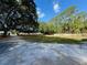 Expansive lot with mature trees, a long driveway, and a well-maintained grassy area at 4981 Lake Cecile Dr, Kissimmee, FL 34746