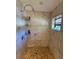 Marble-tiled walk-in shower featuring mosaic floor and a wall-mounted shower head at 4981 Lake Cecile Dr, Kissimmee, FL 34746