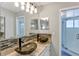 Modern bathroom featuring dual vessel sinks, granite countertops, stylish lighting, and a glass-enclosed shower at 5039 Jamaica # 10, Orlando, FL 32808