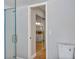 Bright bathroom featuring a glass door shower and mirrored closet doors at 5039 Jamaica # 10, Orlando, FL 32808