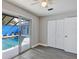 Bright bedroom features wood-look floors, a ceiling fan, and direct access to the pool at 5039 Jamaica # 10, Orlando, FL 32808