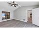 Bedroom with a large window with shutters, wood-look floors and light gray walls at 5039 Jamaica # 10, Orlando, FL 32808