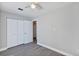 Bright bedroom featuring wood-look flooring, a ceiling fan, and double door closet at 5039 Jamaica # 10, Orlando, FL 32808
