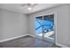 Relaxing bedroom with sliding glass doors that open to the pool area and a ceiling fan at 5039 Jamaica # 10, Orlando, FL 32808