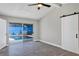 Bedroom with sliding glass doors to the pool, grey wood-look floors, and a sliding barn door at 5039 Jamaica # 10, Orlando, FL 32808