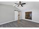Bedroom boasts a view of the kitchen through a doorway, complemented by wood-look floors and a barn-style sliding door at 5039 Jamaica # 10, Orlando, FL 32808