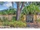 Island Club community entrance featuring lush tropical landscaping at 5039 Jamaica # 10, Orlando, FL 32808