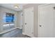 Hallway with grey wood-look floors with white trim and doors, and a window with a view of the pool area at 5039 Jamaica # 10, Orlando, FL 32808