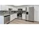 Modern kitchen with stainless steel appliances, granite counters, and white cabinets at 5039 Jamaica # 10, Orlando, FL 32808