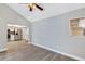 Living room showcases laminate floors and an open view into the adjacent modern kitchen at 5039 Jamaica # 10, Orlando, FL 32808