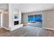Open concept living room with fireplace, sliding glass doors to the pool area, and wood-look floors at 5039 Jamaica # 10, Orlando, FL 32808