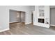 Spacious living area featuring a white brick fireplace and new laminate flooring throughout at 5039 Jamaica # 10, Orlando, FL 32808