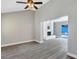 Open-concept living area with a ceiling fan, white brick fireplace, and views of the pool area at 5039 Jamaica # 10, Orlando, FL 32808