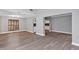 Open concept living room area featuring wood-look floors and ample natural light at 5039 Jamaica # 10, Orlando, FL 32808