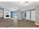 Open-concept living room with a fireplace and sliding glass doors to the pool area at 5039 Jamaica # 10, Orlando, FL 32808
