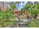 Lush community with landscaped pond featuring a rock waterfall and tropical plants at 5039 Jamaica # 10, Orlando, FL 32808
