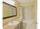 Bathroom with tile flooring, a framed mirror, a sink, a toilet and tiled shower and bathtub combination at 508 Key Ct, Orlando, FL 32828