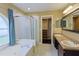Main bathroom featuring double sinks, a large mirror, a soaking tub, and a walk-in closet at 508 Key Ct, Orlando, FL 32828