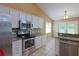 Updated kitchen has stainless appliances, granite counters, and a breakfast bar with tile floors at 508 Key Ct, Orlando, FL 32828