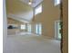 Open concept living room with high ceilings has stone accent wall and door to covered porch at 508 Key Ct, Orlando, FL 32828