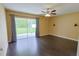 Hardwood living room with sliding glass doors leading to the backyard and a ceiling fan at 508 Key Ct, Orlando, FL 32828