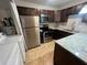 Beautiful kitchen featuring stainless steel appliances and dark wood cabinetry at 51 Windtree Ln # 101, Winter Garden, FL 34787
