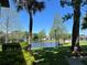 Picturesque pond with a fountain, surrounded by lush greenery and trees, offering a tranquil view at 51 Windtree Ln # 101, Winter Garden, FL 34787