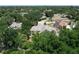 Spacious home on a wooded lot, showcased in a scenic aerial view at 5852 Medinah Way, Orlando, FL 32819
