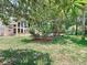 Serene backyard featuring lush greenery and a view of the home's expansive windows at 5852 Medinah Way, Orlando, FL 32819