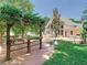 Beautiful backyard featuring a pergola, lush green lawn, and an attractive building at 5852 Medinah Way, Orlando, FL 32819