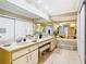 Bright bathroom featuring a large vanity, tub and lots of storage at 5852 Medinah Way, Orlando, FL 32819