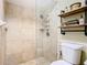 Modern bathroom with tiled shower and storage shelving at 5852 Medinah Way, Orlando, FL 32819
