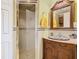 Bathroom featuring a charming vanity with decorative bowl sink and tiled shower stall at 5852 Medinah Way, Orlando, FL 32819