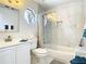 Updated bathroom featuring tiled walls, sleek glass shower door and modern fixtures for a clean aesthetic at 5852 Medinah Way, Orlando, FL 32819