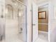 Luxurious bathroom featuring a glass shower with tiled walls and an open doorway to an adjacent room at 5852 Medinah Way, Orlando, FL 32819