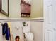 Well-lit bathroom with a decorative cabinet, custom shelf, and updated fixtures at 5852 Medinah Way, Orlando, FL 32819