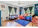 Bright bedroom with colorful decor, blue accent wall, and lots of natural light at 5852 Medinah Way, Orlando, FL 32819
