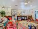 Expansive bedroom showcasing hardwood floors, play items, and mural, fostering a stimulating and imaginative environment at 5852 Medinah Way, Orlando, FL 32819
