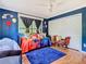 Vibrant bedroom featuring a daybed, unique decor, and a spacious closet at 5852 Medinah Way, Orlando, FL 32819